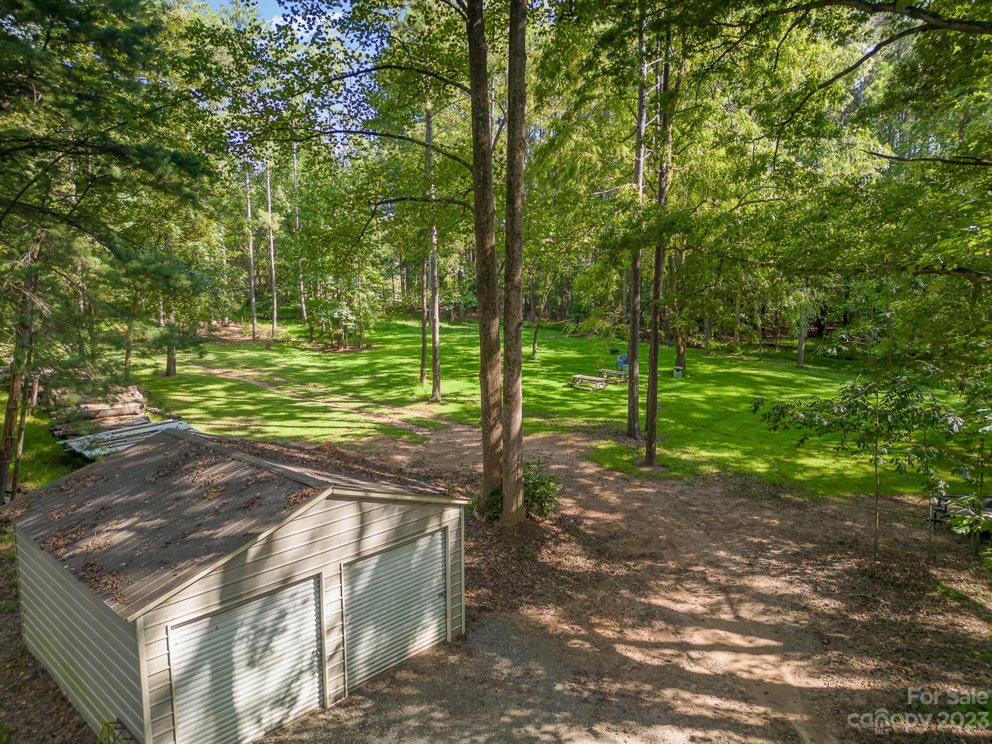 Behind the metal building in the back is a beautiful open recreational area for group/family picnics and gatherings. - 2756 Peachtree Road, Statesville