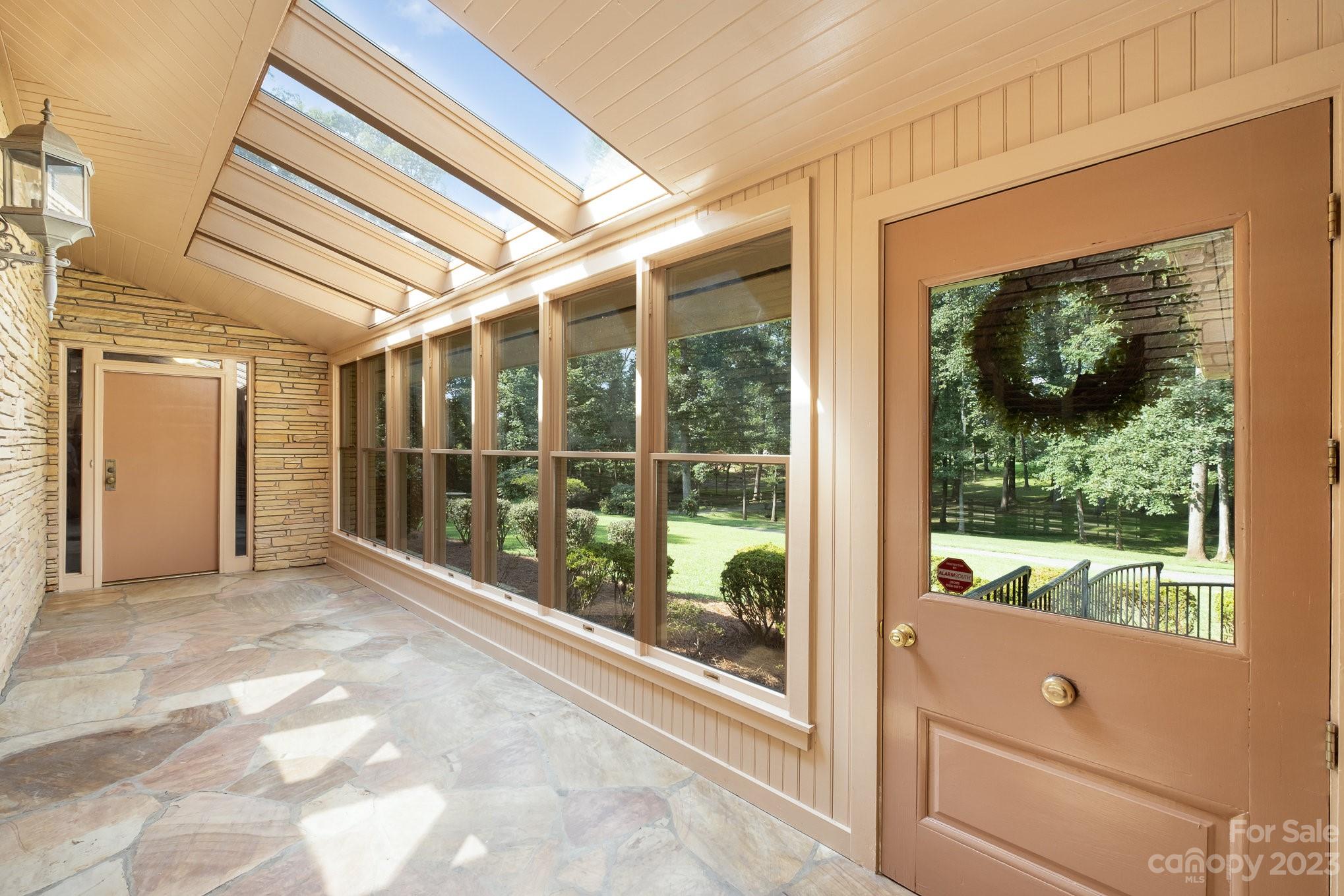 Incredible entrance from front door to front door.  Stone floor, windowed skylighted entrance. - 2756 Peachtree Road, Statesville