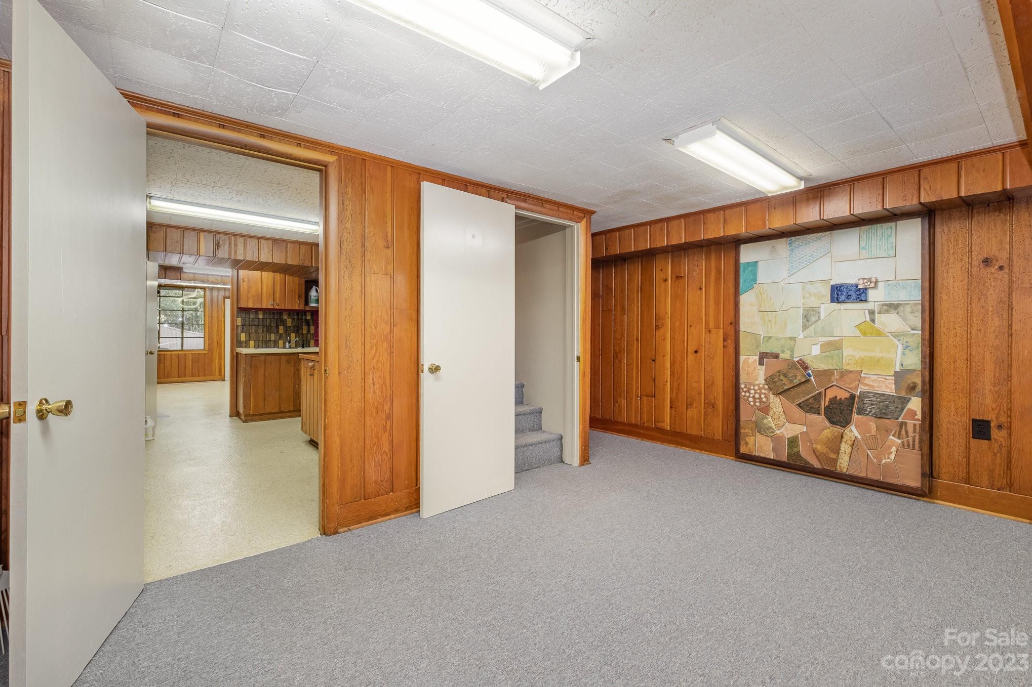 This piece of art will stay.  The door leads to Utility, office/craft/art room. - 2756 Peachtree Road, Statesville