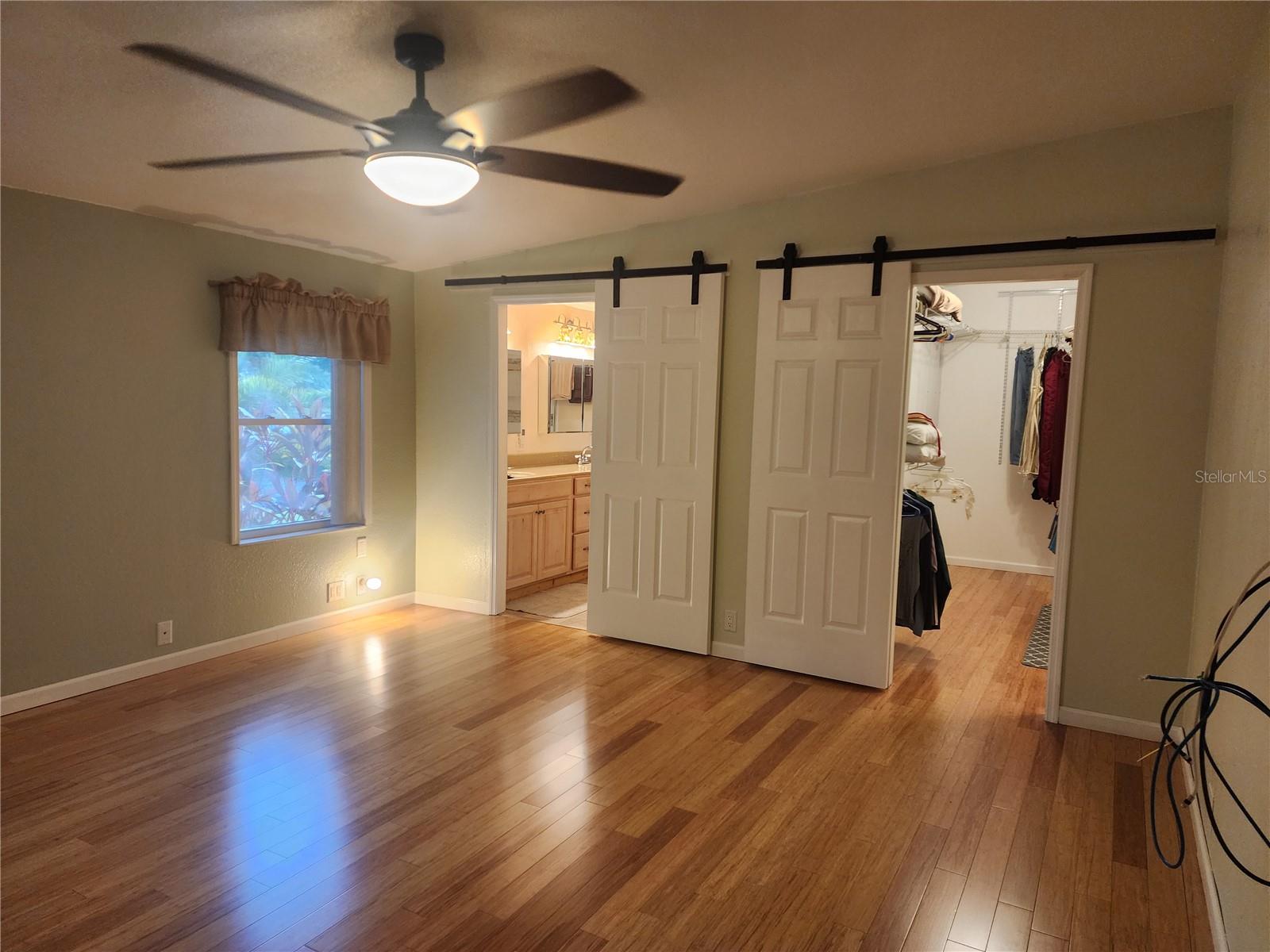 MASTER BEDROOM WITH 2 OF THE 3 BARN DOORS...ONE FOR CLOSET AND OTHER FOR BATH - 14902 ARRENA RD, WINTER GARDEN