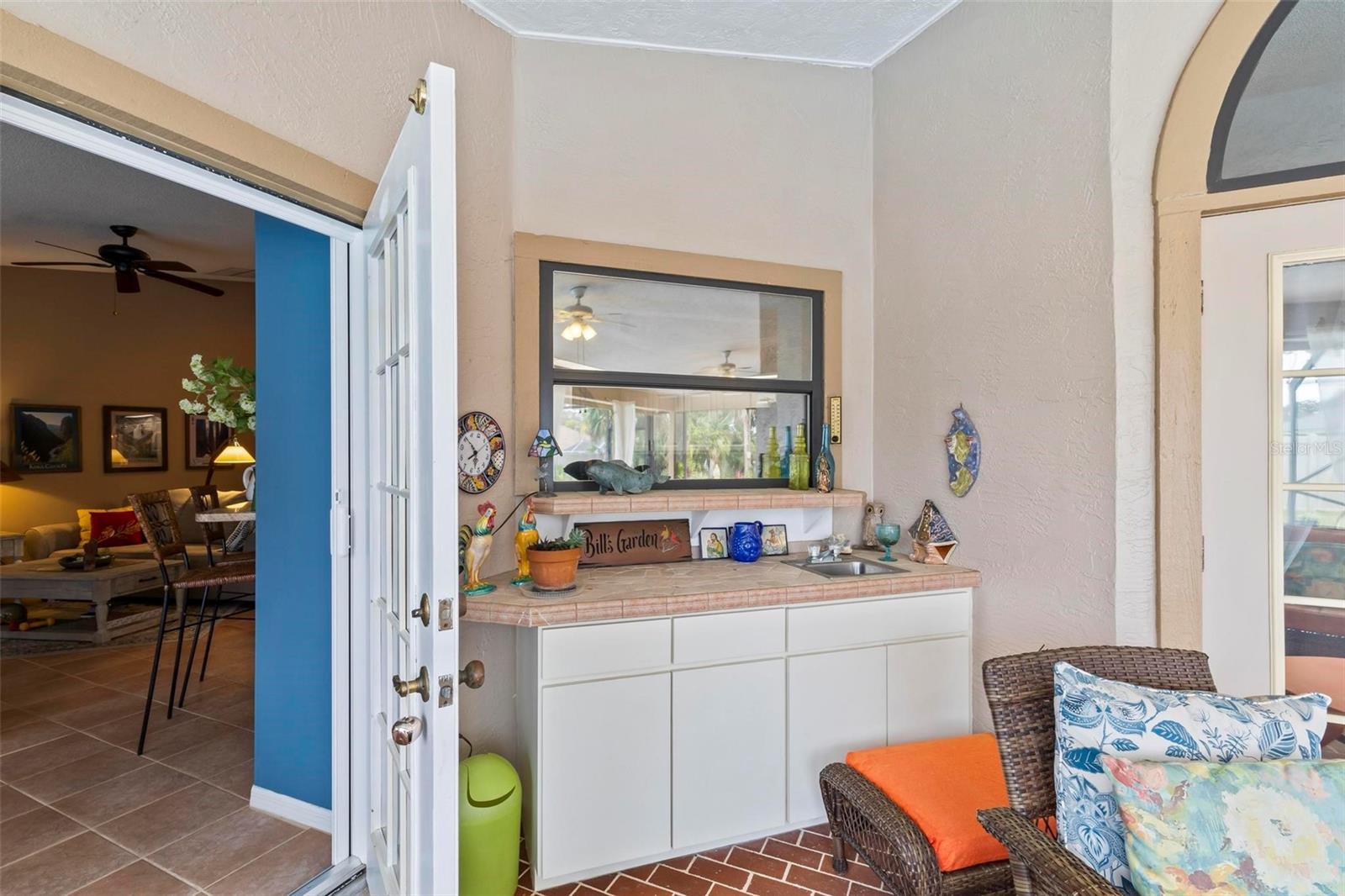 Lanai wet bar with service window from kitchen - 130 BAYSIDE DR, PALM COAST