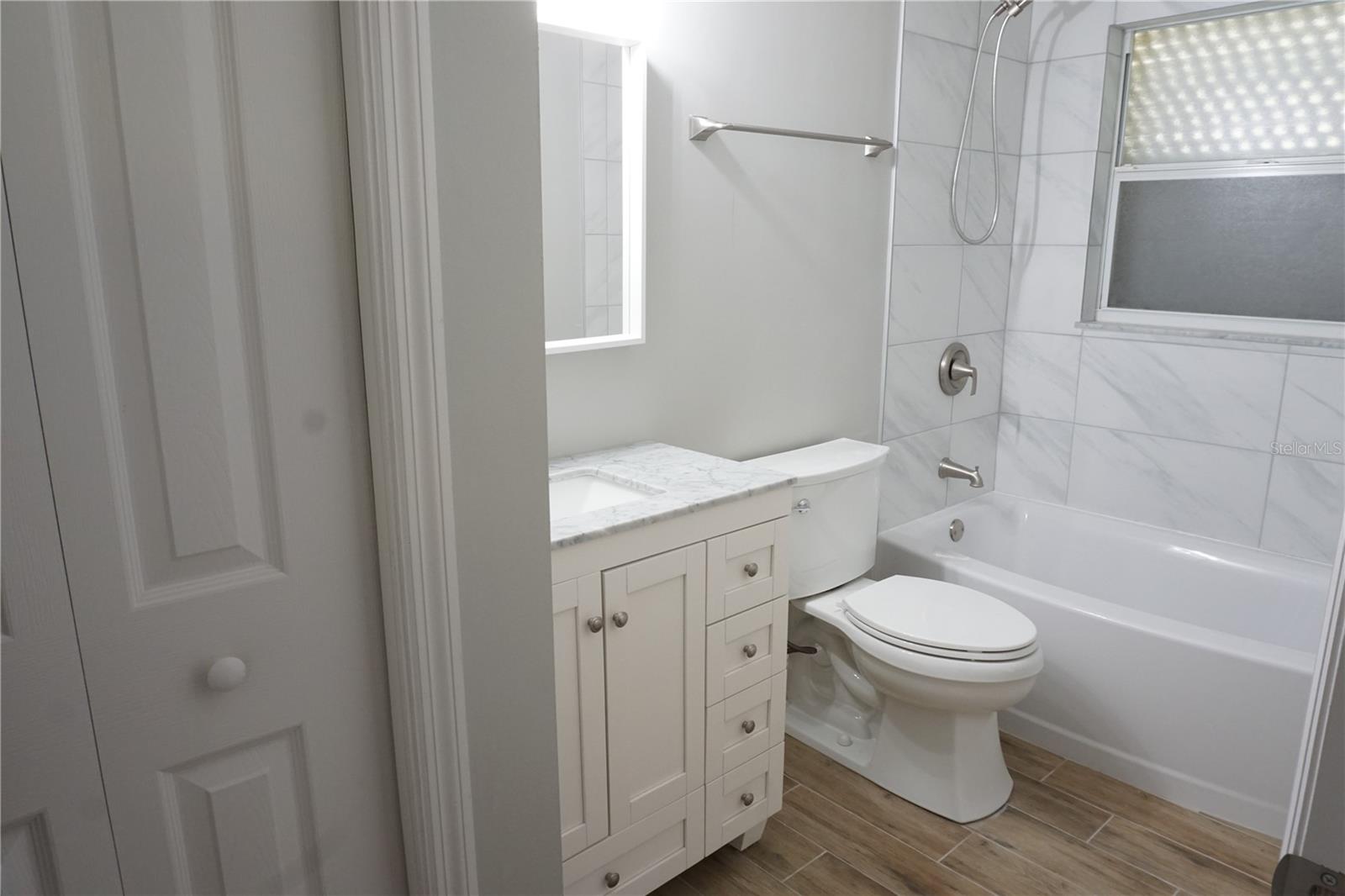 Remodeled guest bath with tub/shower combo - 2000 BAL HARBOR BLVD #1012, PUNTA GORDA
