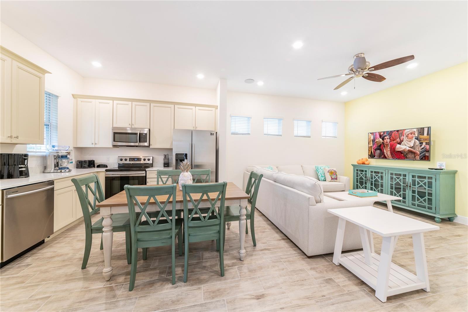 Open kitchen and dining with stainless appliances in Margaritaville Resort Orlando near Disney - 2988 SALTED RIM RD, KISSIMMEE