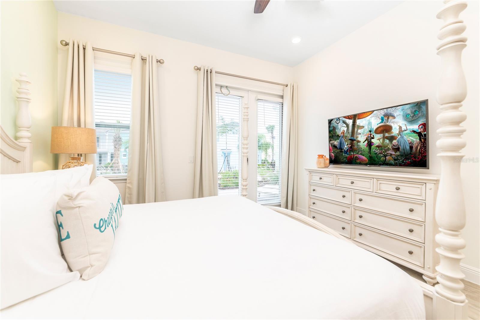 Bright primary bedroom with coastal décor and large windows in Kissimmee vacation home - 2988 SALTED RIM RD, KISSIMMEE