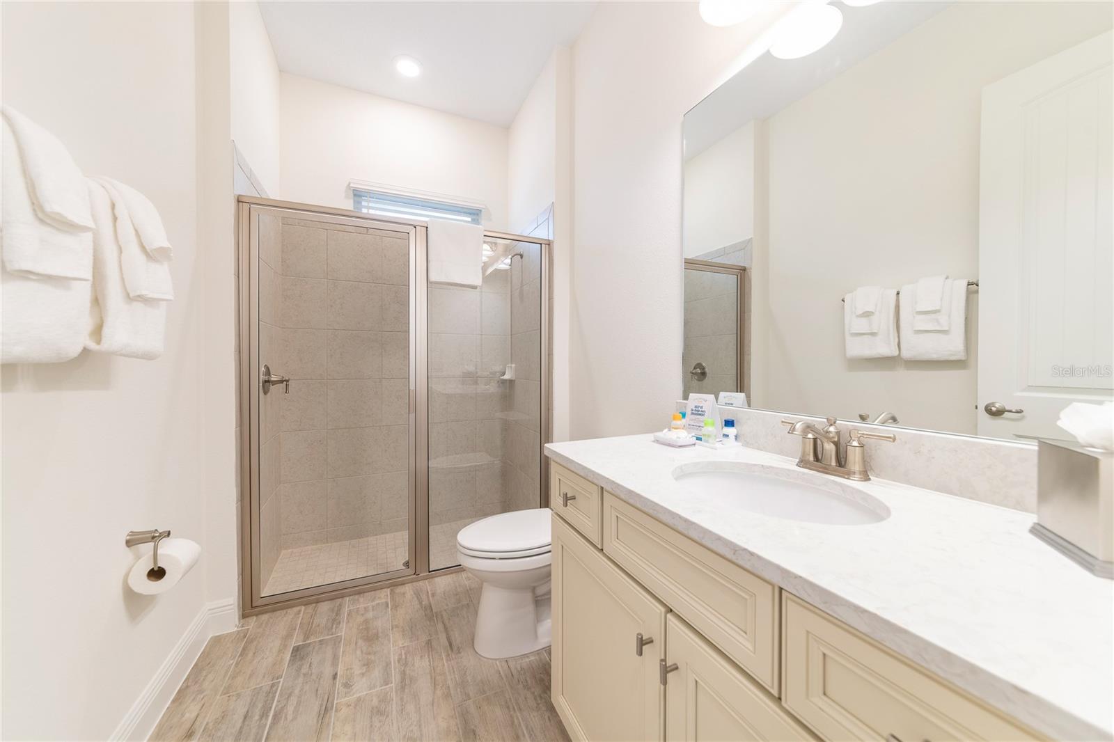 Primary bathroom with dual sinks and walk in shower in Kissimmee resort style home - 2988 SALTED RIM RD, KISSIMMEE