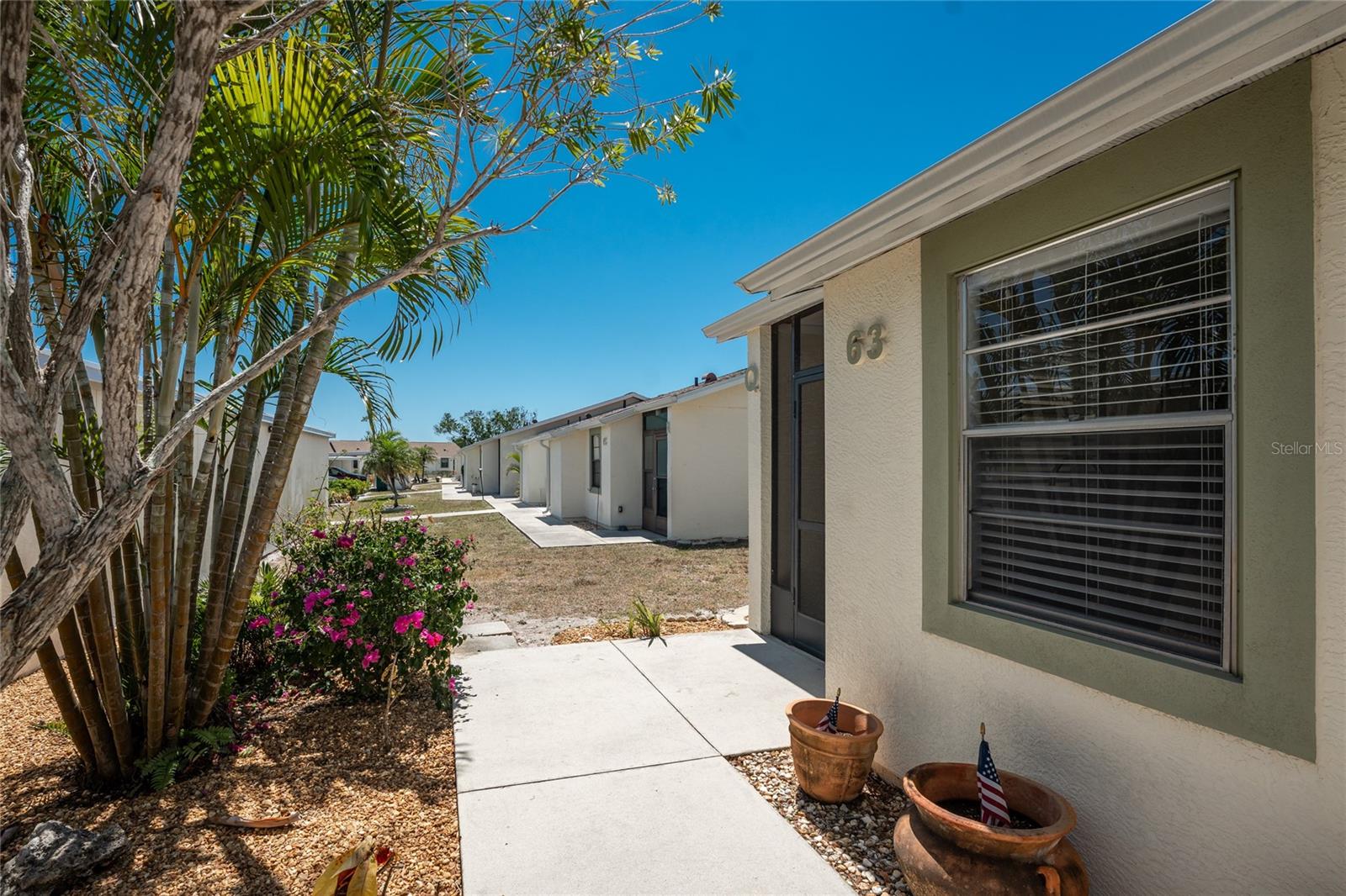 There's a pretty, landscaped walkway up to the front door of this updated 2 BEDROOM/ 2 BATH condo in Village of Wildflower! - 6796 GASPARILLA PINES BLVD #63, ENGLEWOOD