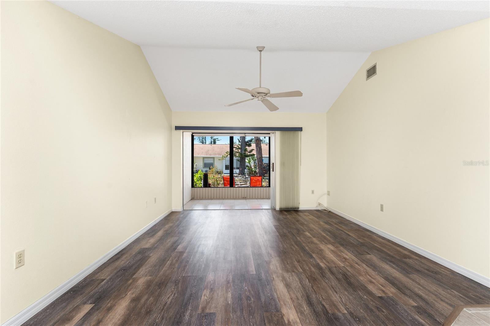 Main living area has a cathedral ceiling and ceiling fan, plus sliding glass doors to the lanai. - 6796 GASPARILLA PINES BLVD #63, ENGLEWOOD
