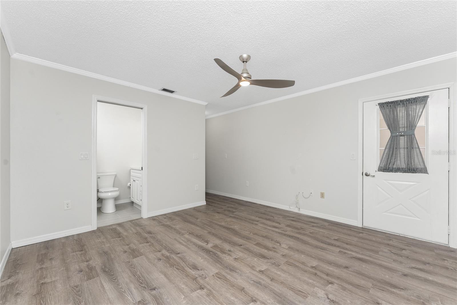 Primary bedroom has a wall closet, ceiling fan and crown moulding to add a decorative touch! - 6796 GASPARILLA PINES BLVD #63, ENGLEWOOD