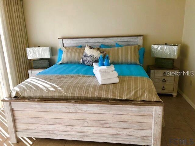 Primary Bedroom-King bed-sliders to balcony, two walk-in closets. Ensuite bathroom - 104 SURFVIEW DR #2503, PALM COAST