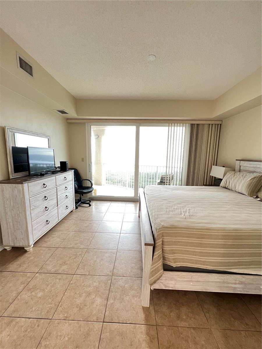 Primary Bedroom-King bed-sliders to balcony, two walk-in closets. Ensuite bathroom - 104 SURFVIEW DR #2503, PALM COAST