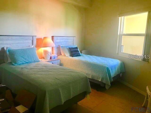 Second bedroom with twin beds and large window - 104 SURFVIEW DR #2503, PALM COAST
