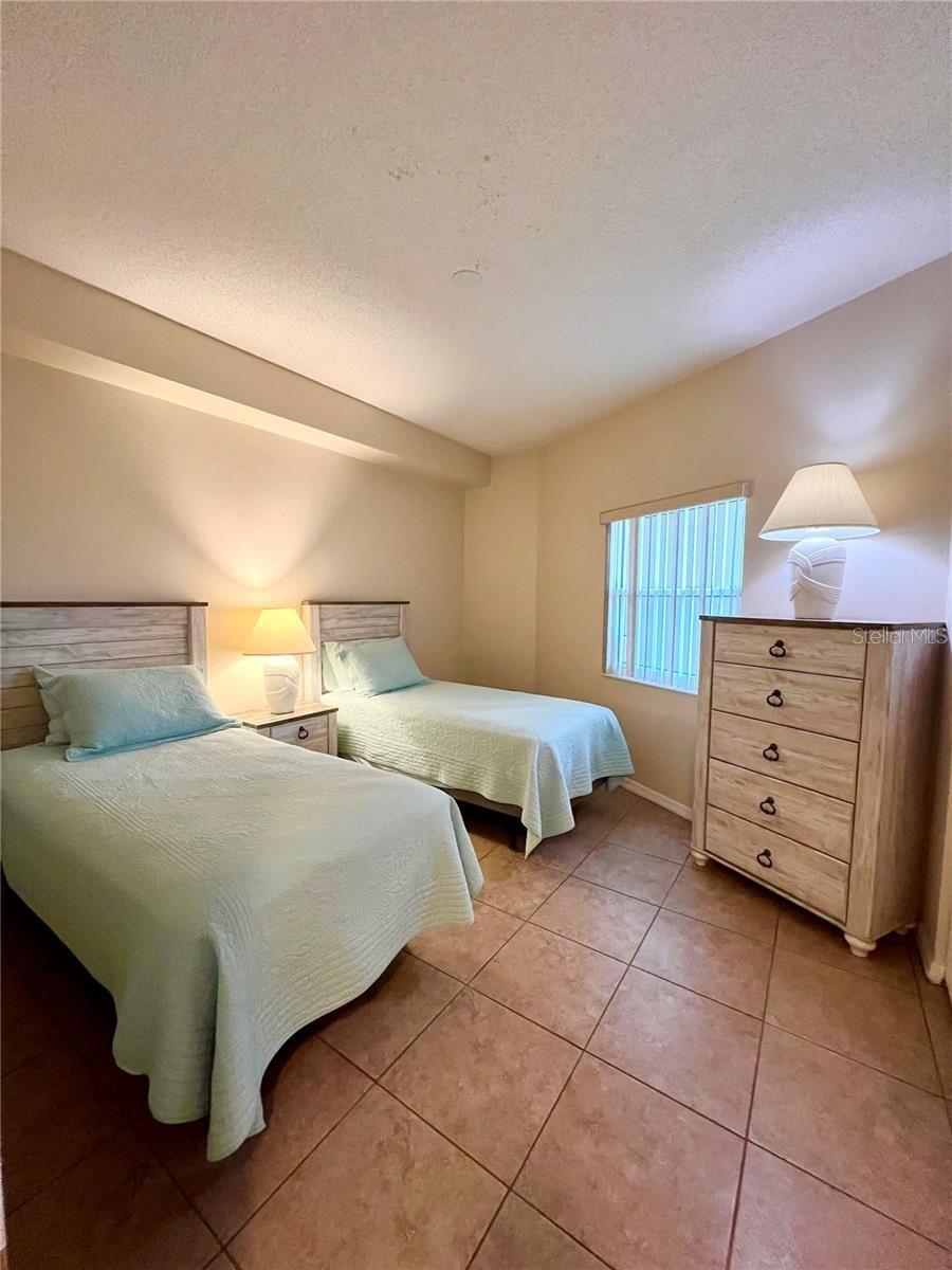 Second bedroom with twin beds and large window - 104 SURFVIEW DR #2503, PALM COAST