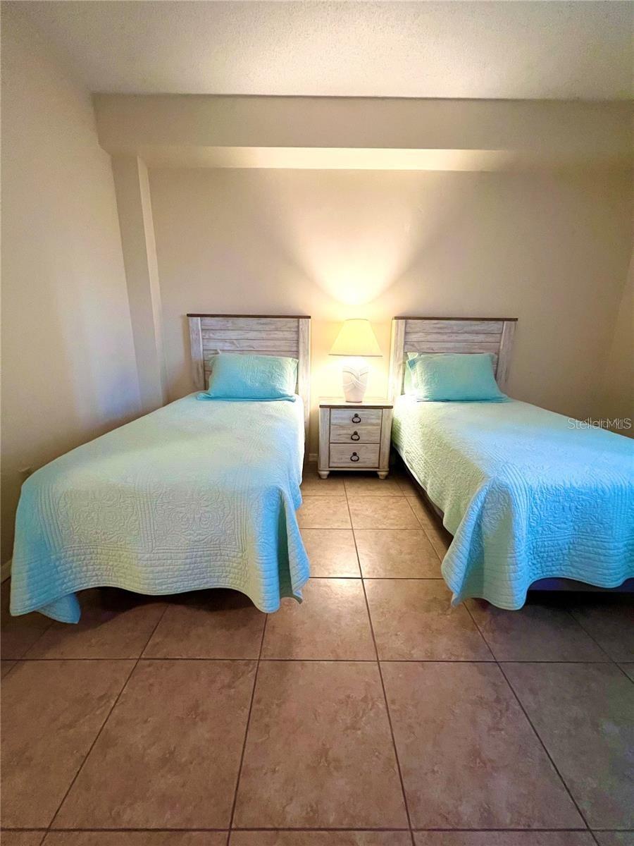 Second bedroom with twin beds and large window - 104 SURFVIEW DR #2503, PALM COAST