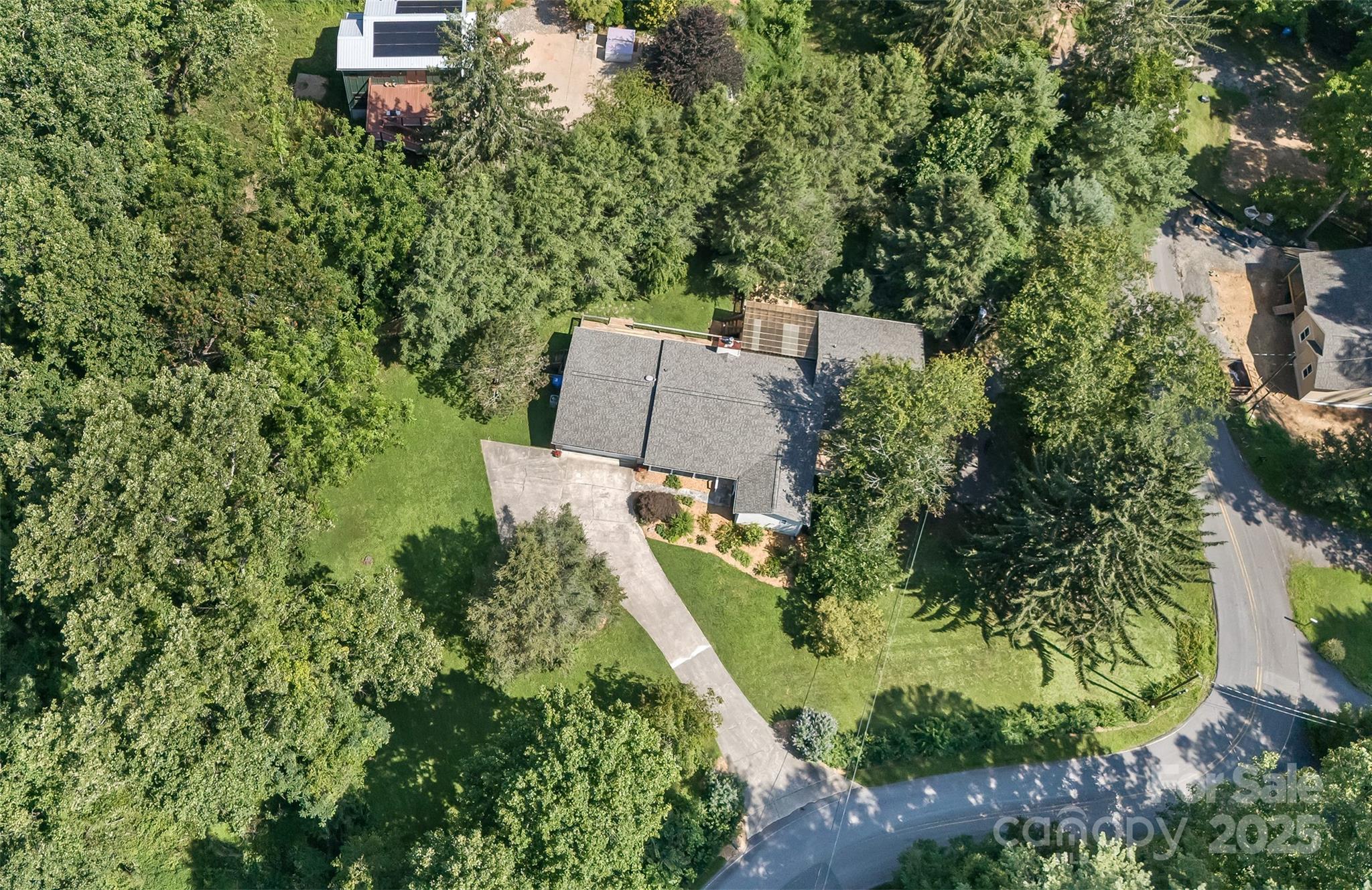 Located just off Beaverdam Road, the home is situated on over an acre with a concrete upper driveway and asphalt lower driveway. - 15 Beaverdam Knoll Road, Asheville