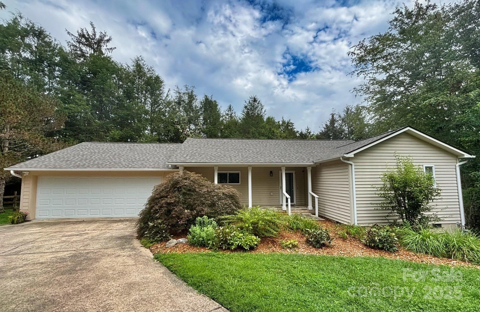 Beautiful landscaping accents the home and provides a haven for an abundance of wildlife. The architectural shingle roof was completed in July 2025. - 15 Beaverdam Knoll Road, Asheville