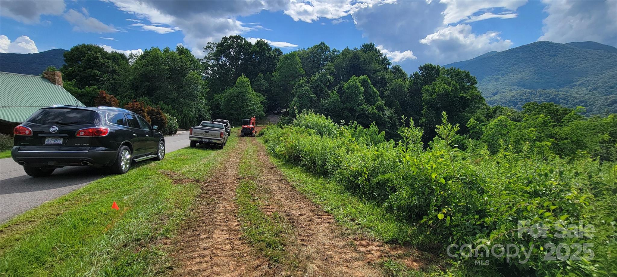 Lot 37 is located between SUV and Excavator.  Red flag is location of UG Elec running parallel with 18 ft wide subd street - 37 Rons Ridge, Waynesville