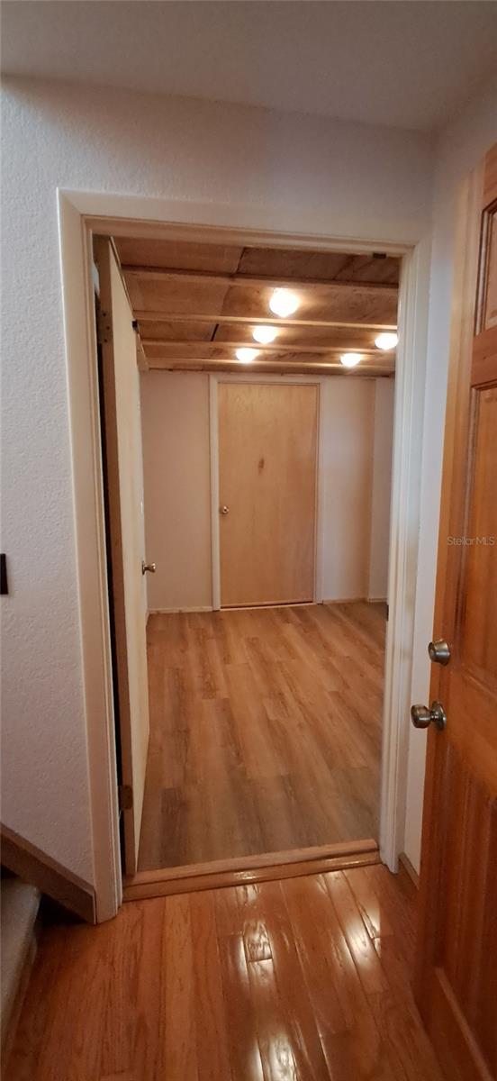 Hallway to 1st set of Stairs, leading to the upstairs Primary Bedroom. Continue straight to the huge Guest Bedroom/Media Room - 2741 EDWARDS RD, HAINES CITY
