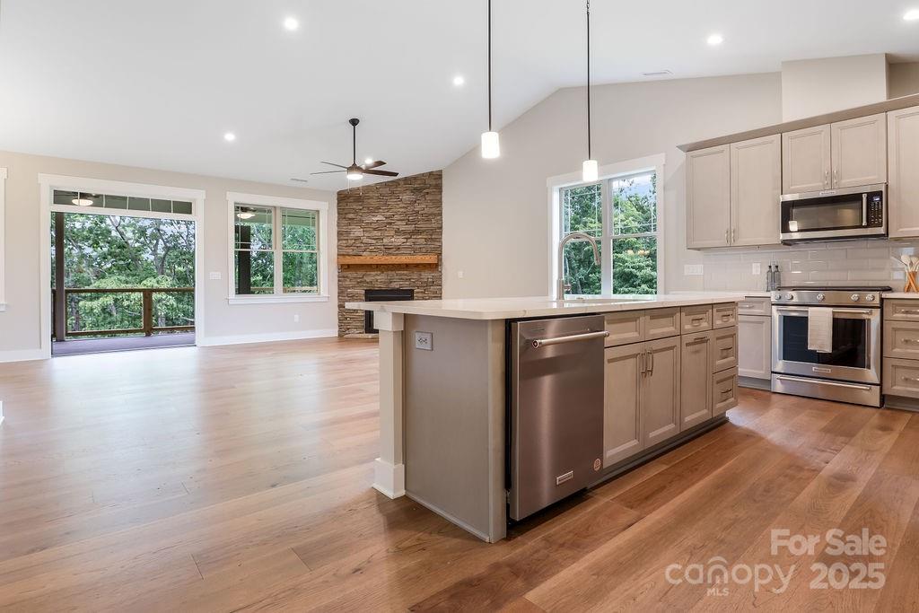 Spacious living area flows to covered Trex decking with peaceful wooded views - 21 Craftsman Overlook Ridge, Arden