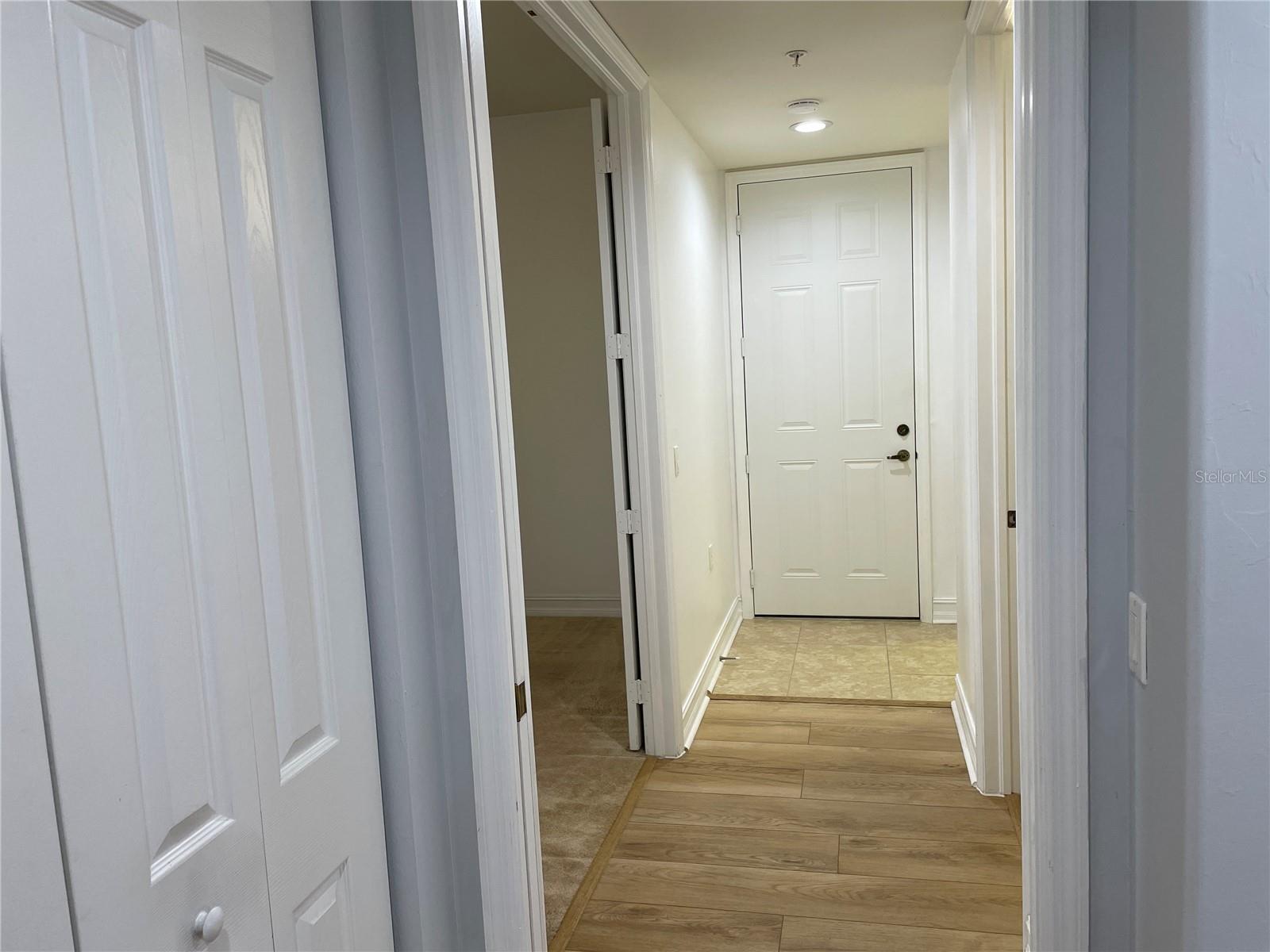 Hallway to the 3rd bedroom, guest bath, laundry room and back door. - 85 VIVANTE BLVD #8534, PUNTA GORDA