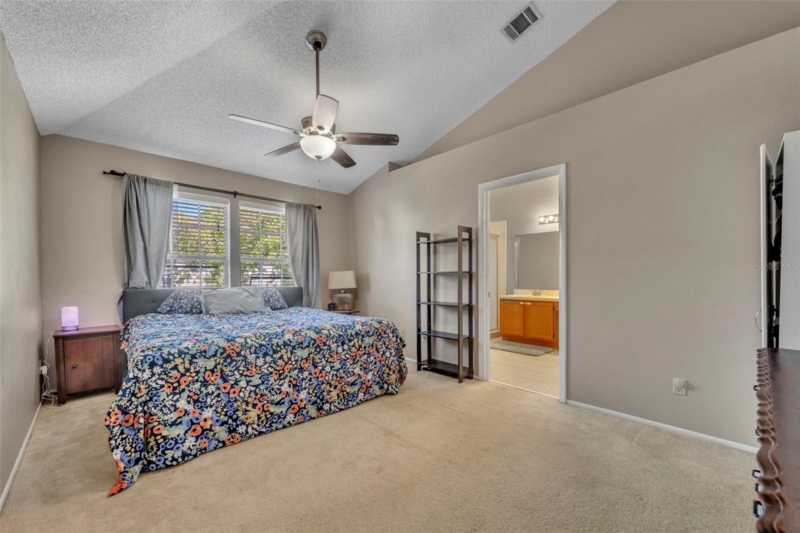 First of two primary bedrooms, a large 11'4" x 16'11" is the perfect for any size bed. Note the ensuite - 2810 CORNERSTONE CT, APOPKA