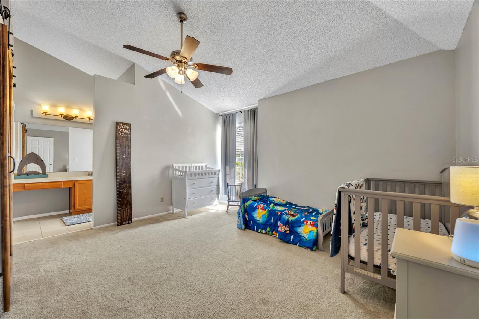 Primary bedroom #2 provides 14'1"x12'8" of sweet dreams. - 2810 CORNERSTONE CT, APOPKA