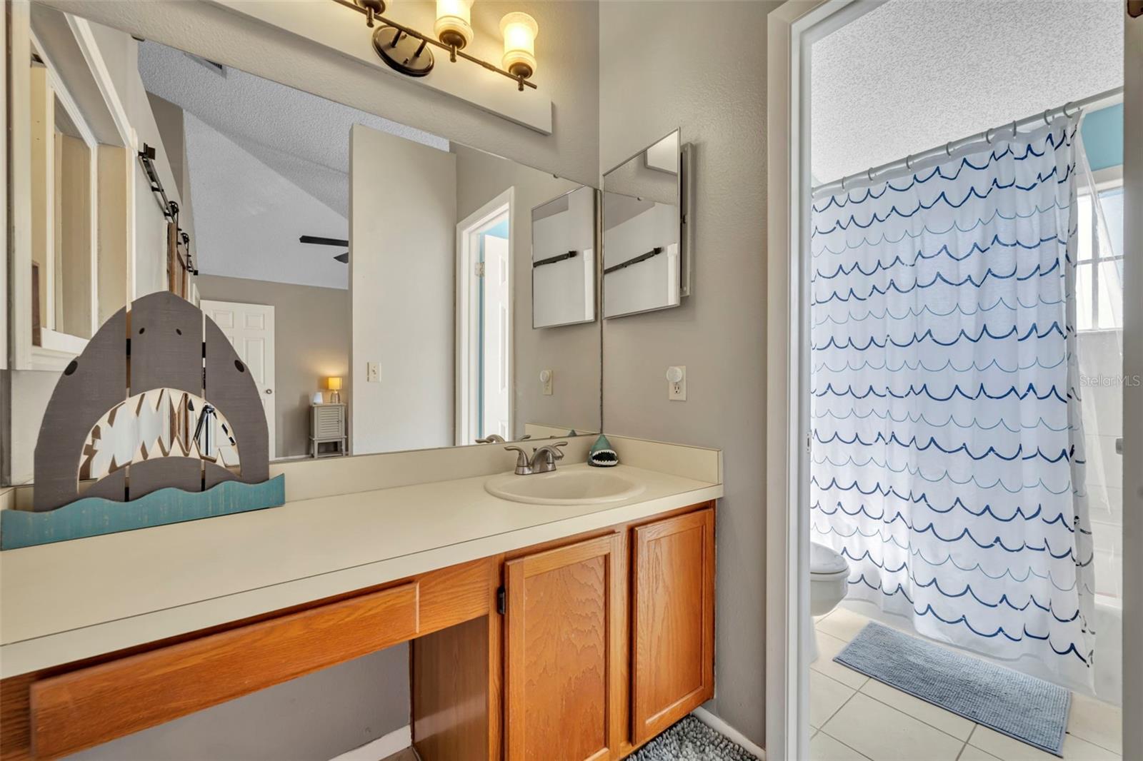 Nice sized vanity in the second primary bedroom that leads to the tub/shower combination. - 2810 CORNERSTONE CT, APOPKA