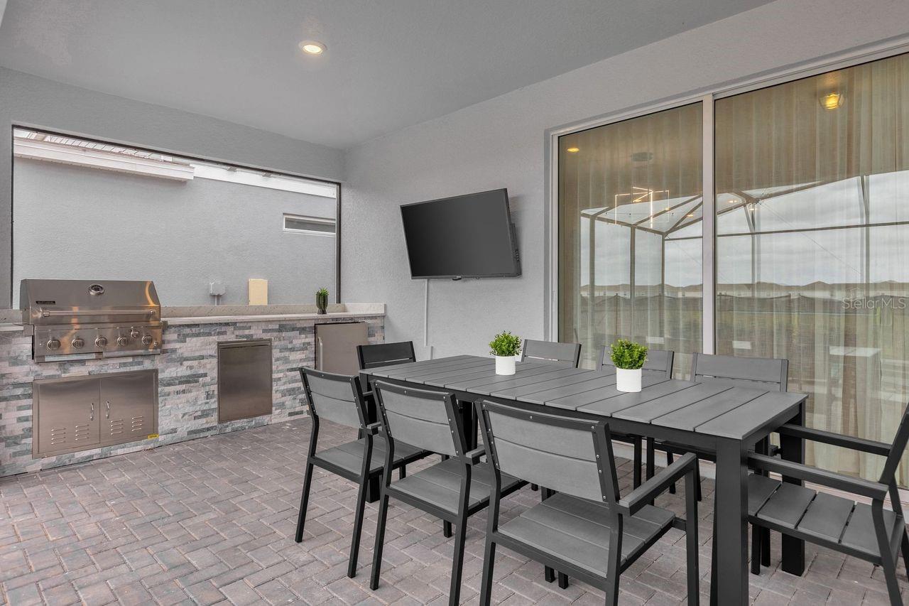 Outdoor - Covered patio with dining table, summer kitchen and conversation set - 3048 MAHALO DR, DAVENPORT