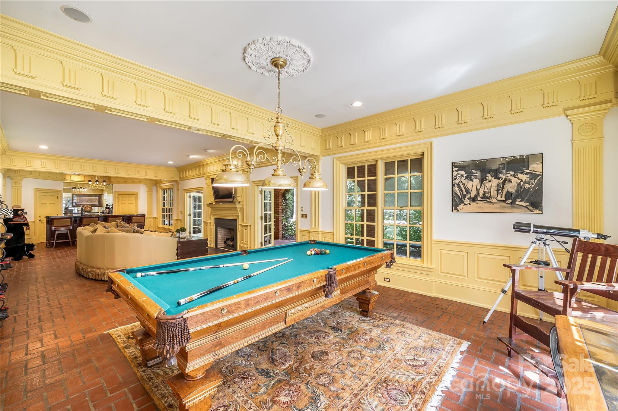 Lower-level family room offers billiards, wet bar, fireplace and the perfect spot to watch the games. The separate media room has a great movie watching atmosphere. The media room has also served as a bedroom when needed. - 2665 Rolling Hills Drive, Monroe