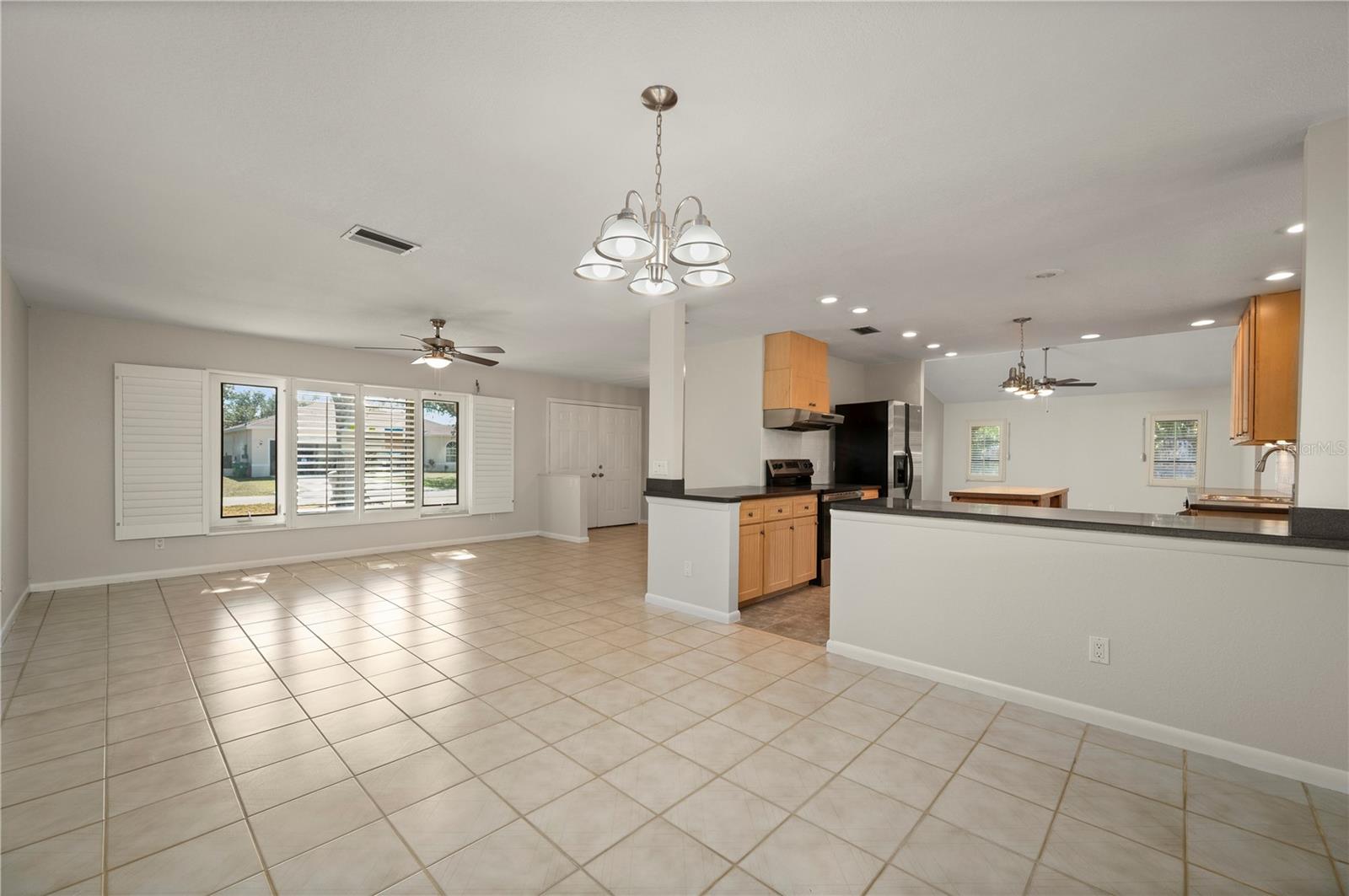 View of the entry to the living room and check out the kitchen. - 17356 GULFSPRAY CIR, PORT CHARLOTTE