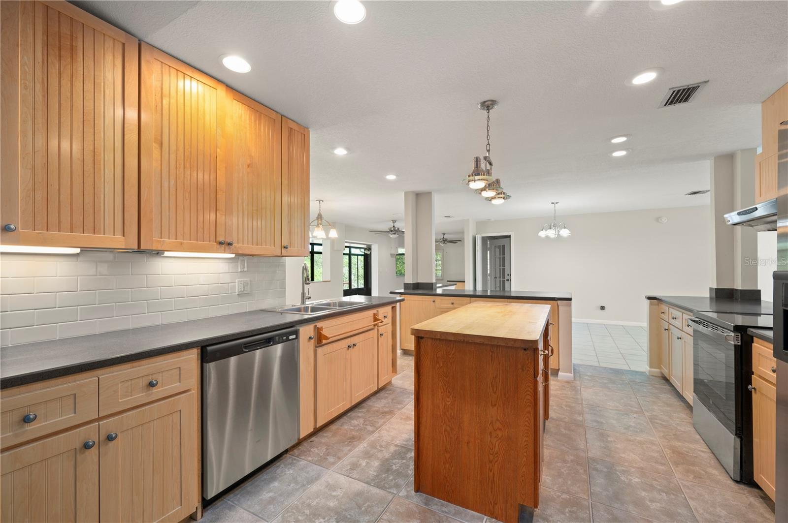 Spacious kitchen with island and abundant cabinetry. - 17356 GULFSPRAY CIR, PORT CHARLOTTE