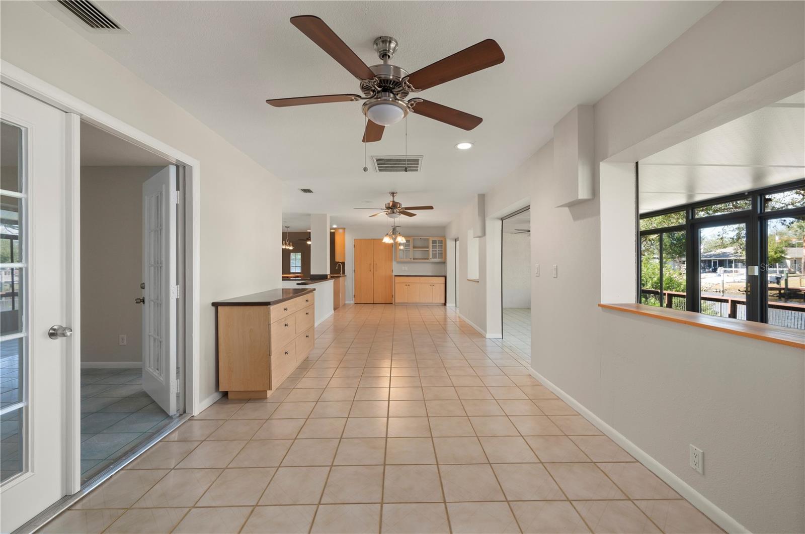The amazing Bonus Room with the Primary Bedroom to the left and the bright Sun Room to the right. - 17356 GULFSPRAY CIR, PORT CHARLOTTE