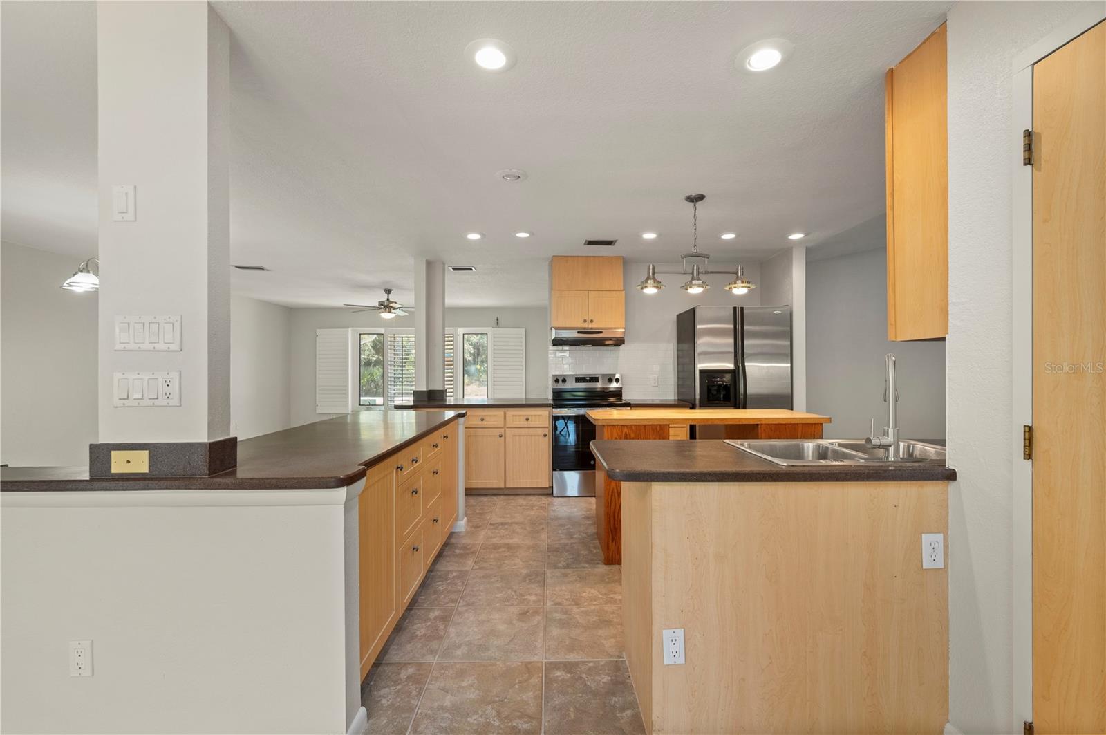 View of the Kitchen from the Bonus Room - 17356 GULFSPRAY CIR, PORT CHARLOTTE