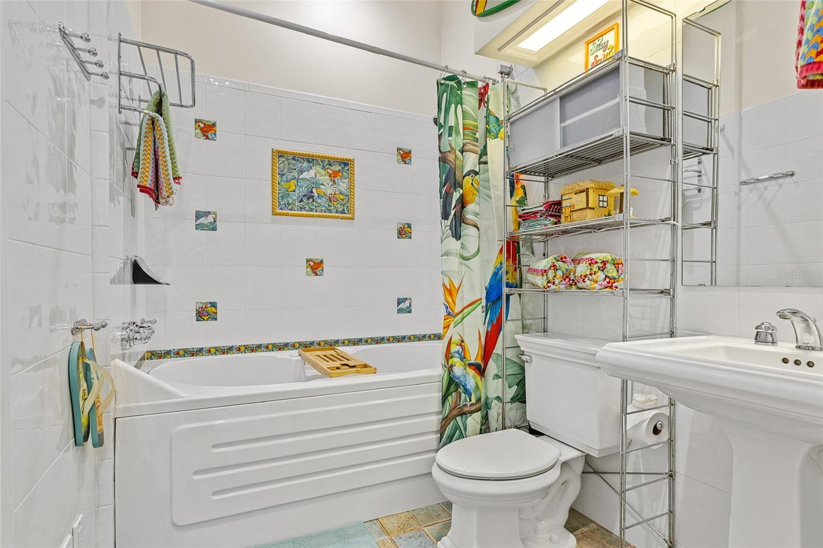 Guest Bathroom w/ jetted soaking tub and Jack & Jill access for Bedroom 2 and hallway entrance. - 6618 S ATLANTIC AVE, NEW SMYRNA BEACH