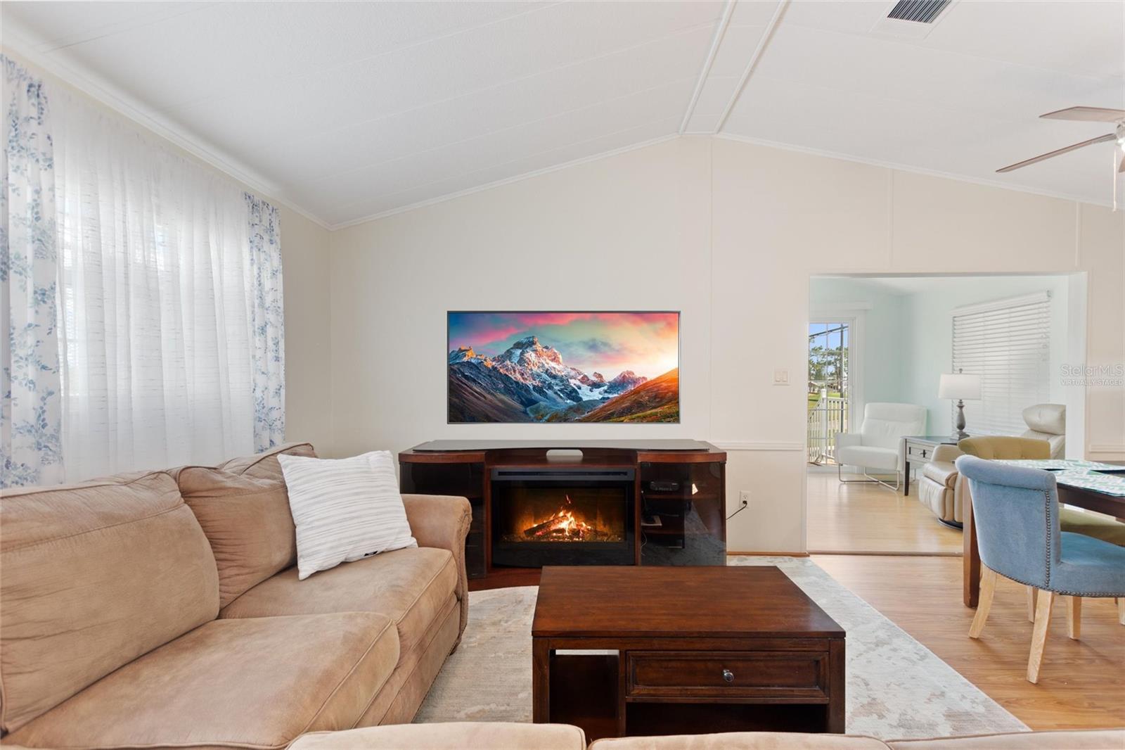 Virtually staged TV and flame in electric fireplace - 16 CHAMPIONSHIP DR, DAVENPORT