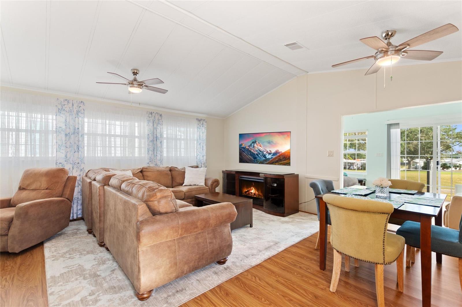 Virtually staged TV and flame in electric fireplace - 16 CHAMPIONSHIP DR, DAVENPORT