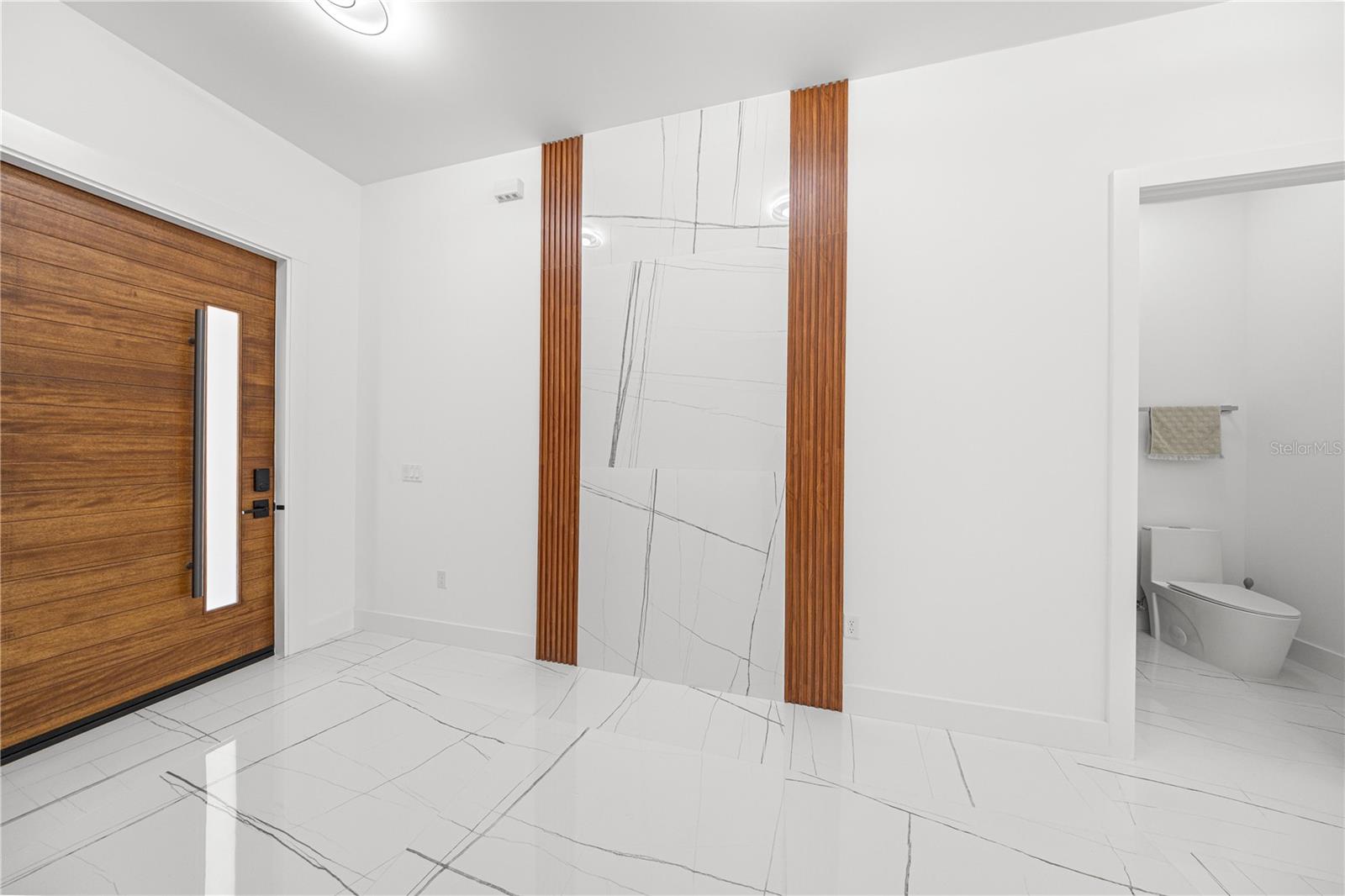 FRONT DOOR - FOYER ENTRANCE AND HALF BATHROOM - 6877 SW 131ST CIR, OCALA