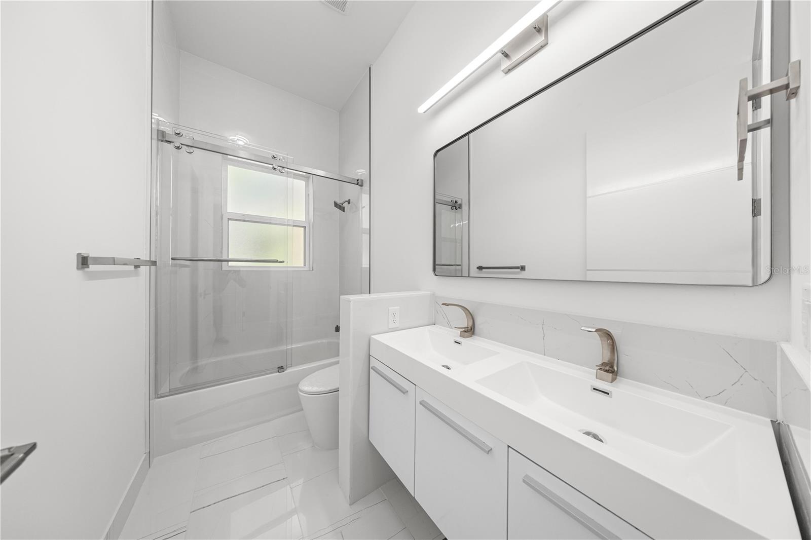 BATHROOM #2 - WALL MOUNTED DUAL SINK VANITY AND BATHTUB/SHOWER - 6877 SW 131ST CIR, OCALA