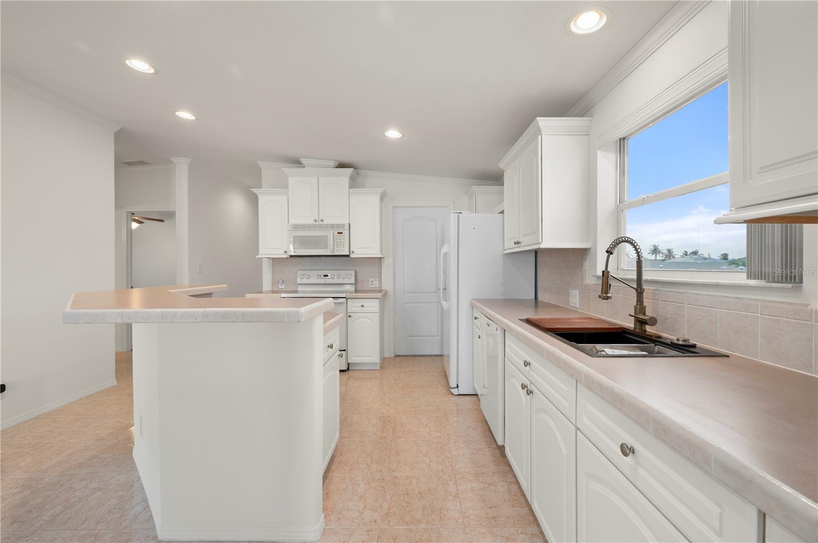 Window at sink gives a westward view - 67 WINDMILL BLVD, PUNTA GORDA