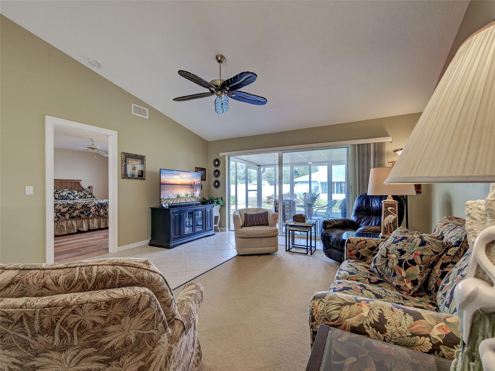 Picture taken from kitchen to show living room with primary bedroom to the left and SGD to the lanai. Villa comes fully turnkey furnished - 6527 HAMLET DR #26B, ENGLEWOOD