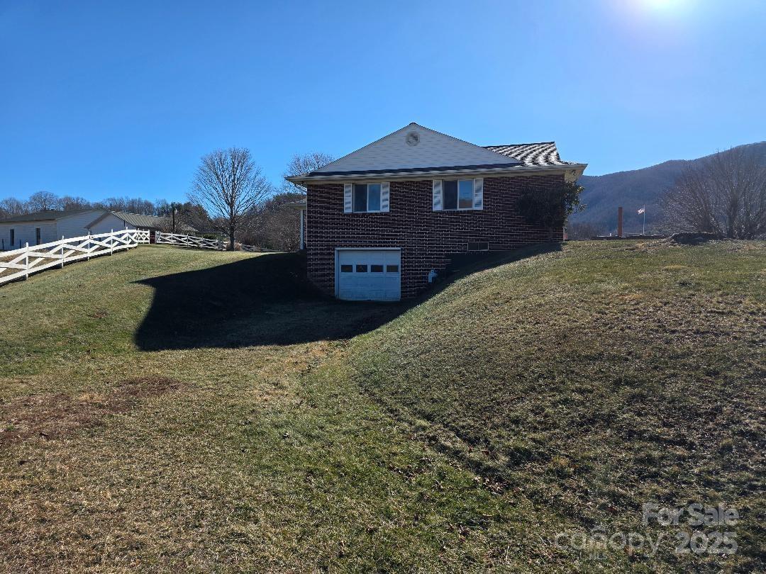 View of north side of house and drive-in basement - 1375 E US Highway 19E Highway, Burnsville