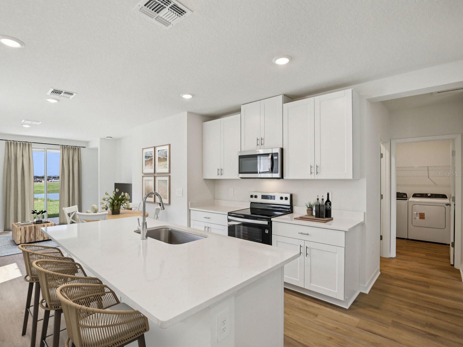 Interior photos are not of the actual home but are photos of the builder home with same floorplan with similar interior finishes and features. Photo uses virtual staging. - 11321 BELLEWOOD TER, PARRISH
