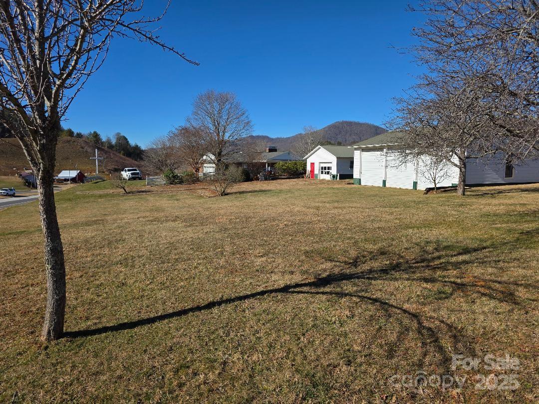 View of large rear lawn, detached garages and rear of house - 1375 E US Highway 19E Highway, Burnsville