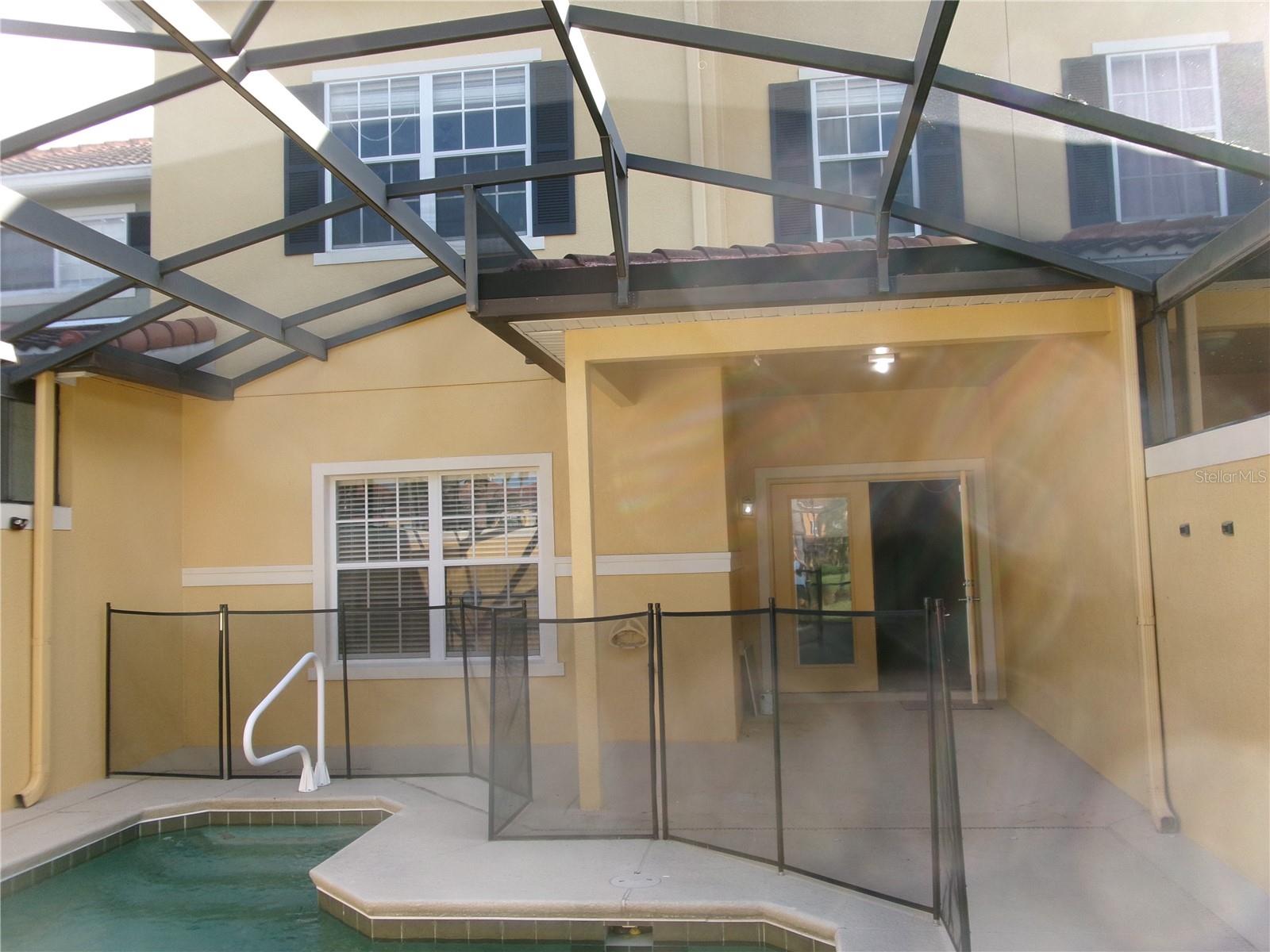 Rear covered patio, pool deck and pool - 8969 MAJESTY PALM RD, KISSIMMEE