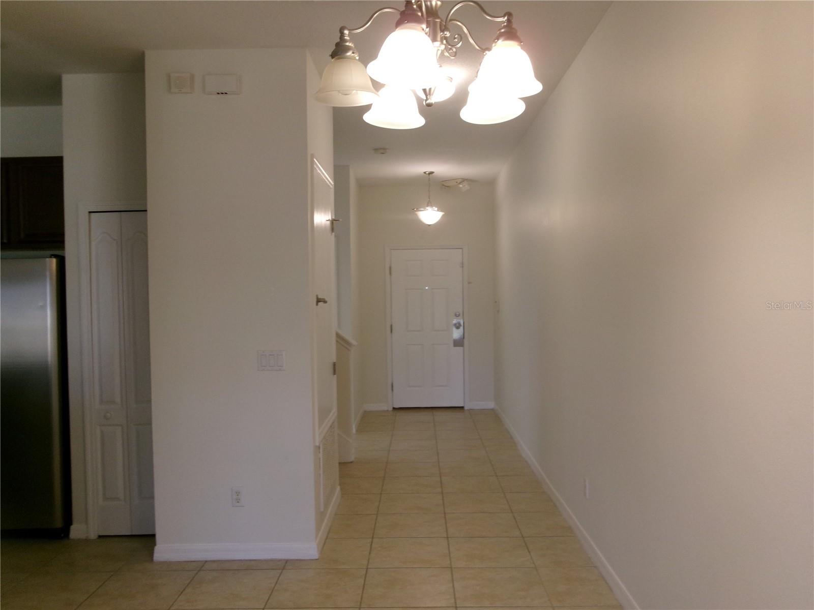 Entry hall view form dining area - 8969 MAJESTY PALM RD, KISSIMMEE