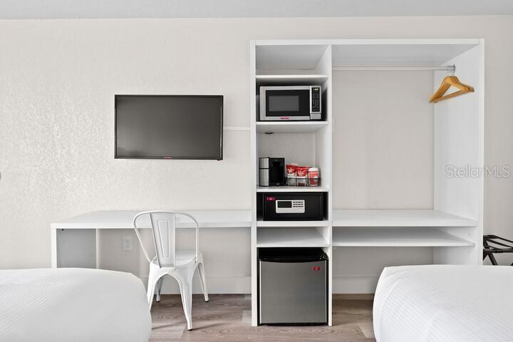 Kitchenette wall with microwave and mini refrigerator - 2930 POLYNESIAN ISLE BLVD #245, KISSIMMEE