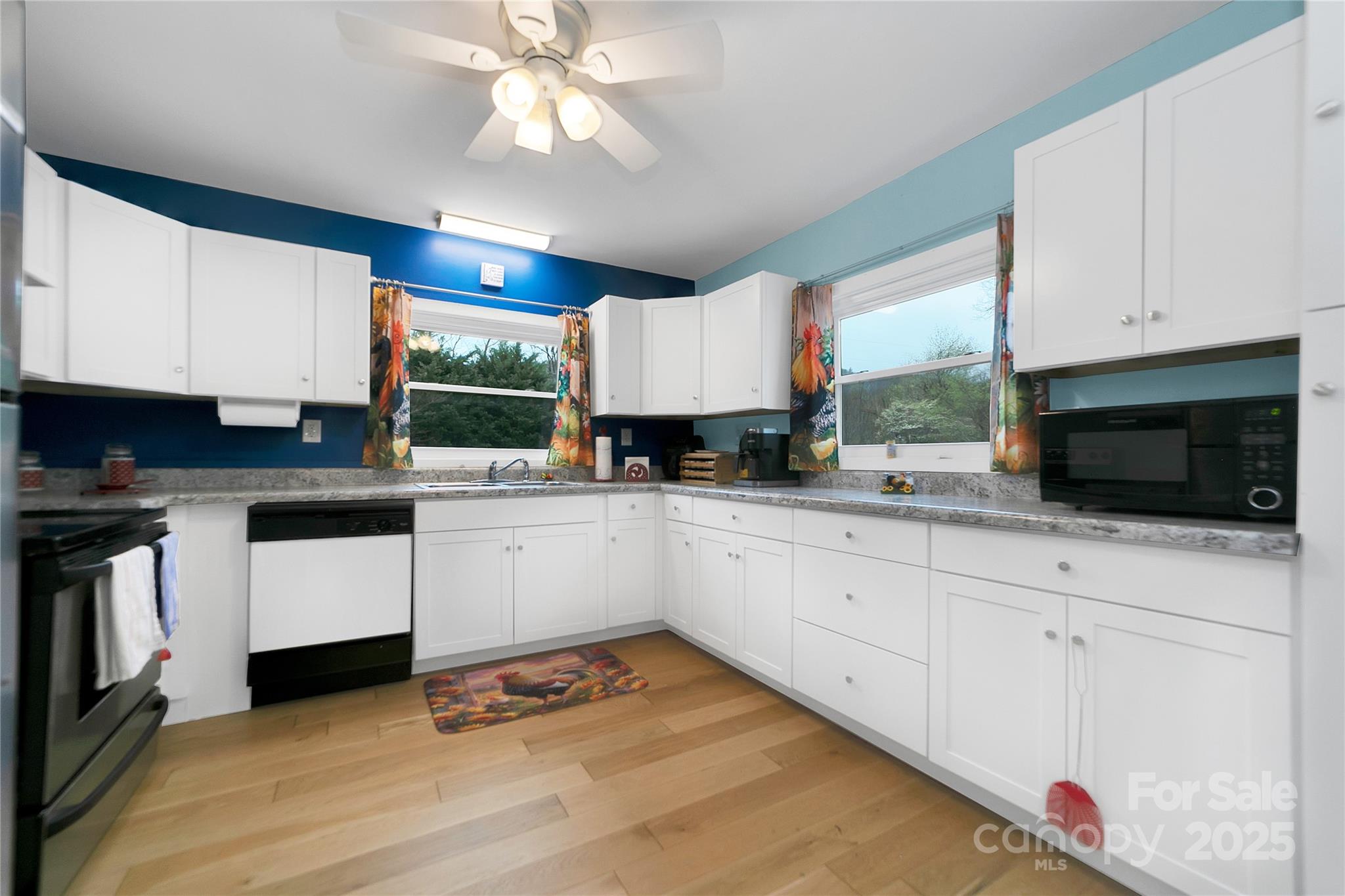 The kitchen is well appointed with appliances and looks out to a lot of green outside! - 626 Fairview Loop, Hot Springs
