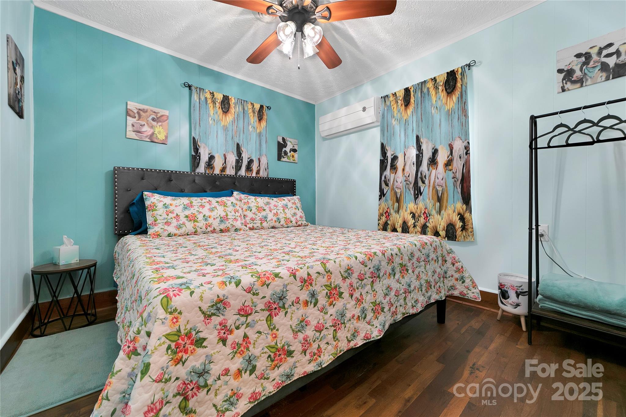 The front bedroom suite boasts its king bed with plenty of space to move around. The entire suite is adorned with adorable heifers at every turn! - 626 Fairview Loop, Hot Springs