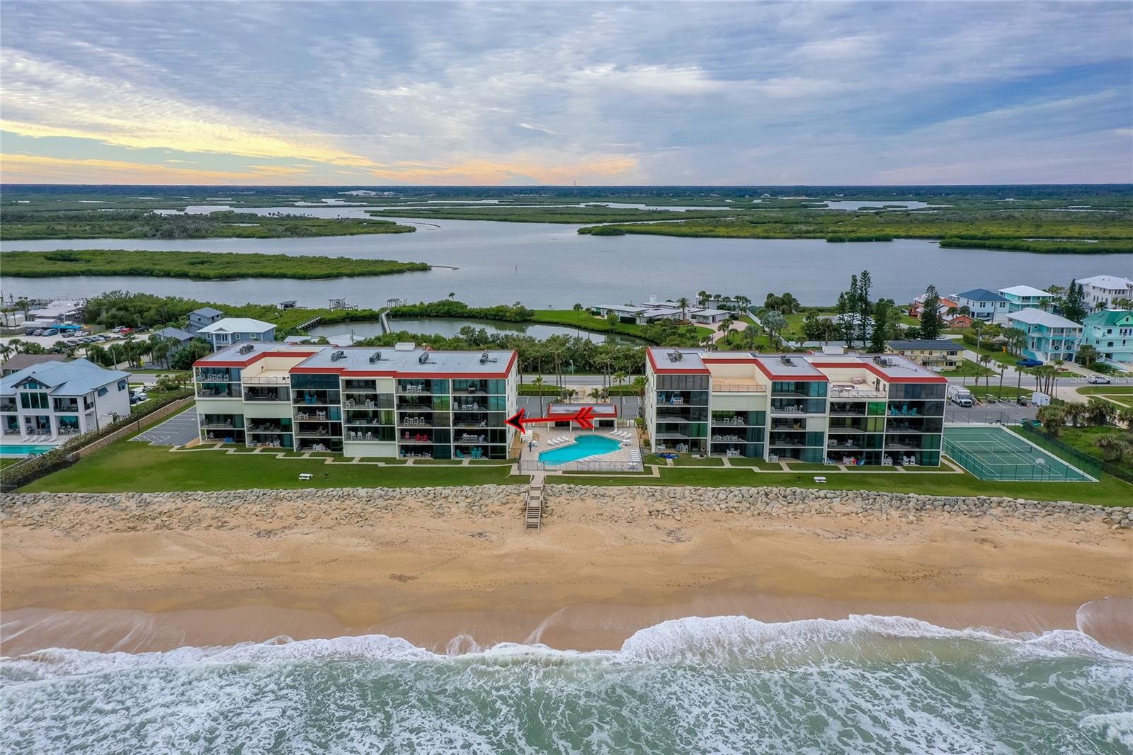 A sweeping ocean-facing view captures the full layout of the development, showcasing both the Atlantic beachfront and lush inland waterways beyond. - 6727 TURTLEMOUND RD #315, NEW SMYRNA BEACH