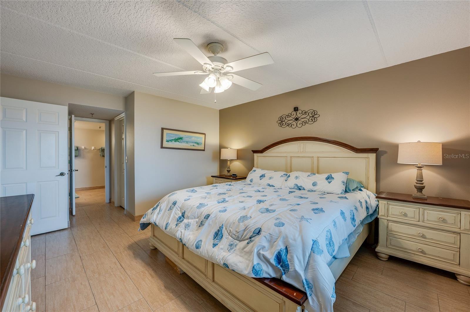 Another angle reveals easy access to the ensuite bathroom and a walk-in layout, with light tile flooring that adds continuity throughout the space. - 6727 TURTLEMOUND RD #315, NEW SMYRNA BEACH