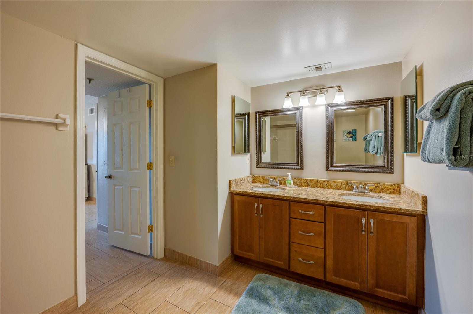 A wider view of the ensuite shows the thoughtful layout and bright lighting, ideal for daily routines. - 6727 TURTLEMOUND RD #315, NEW SMYRNA BEACH